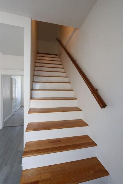 stairway with wood finished floors