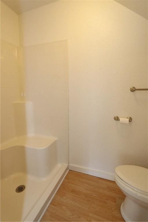 full bath with a shower, baseboards, and wood finished floors