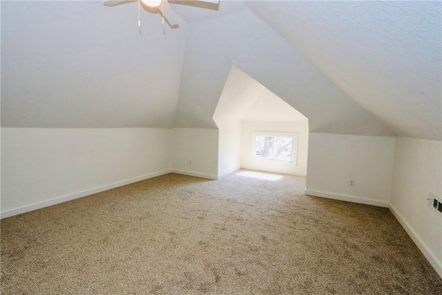 bonus room featuring visible vents, baseboards, carpet floors, lofted ceiling, and ceiling fan