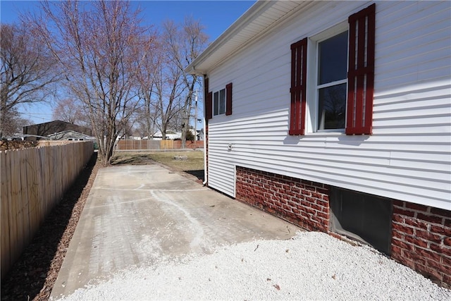 view of property exterior with a patio and fence private yard