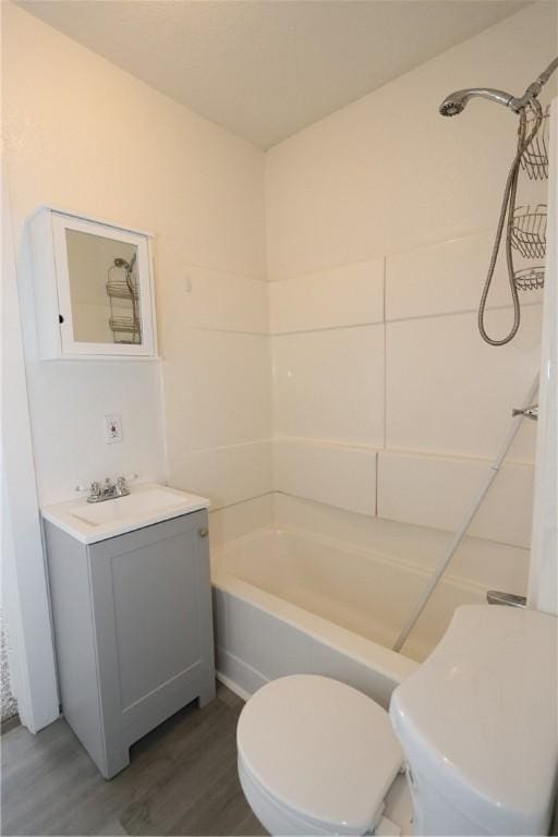 bathroom featuring vanity, toilet, and wood finished floors