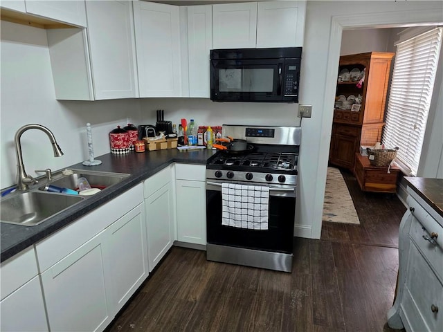 403 11th St, Georgetown, IL 61846 - kitchen with black microwave, stainless steel range with gas stovetop, a sink, and dark wood finished floors
