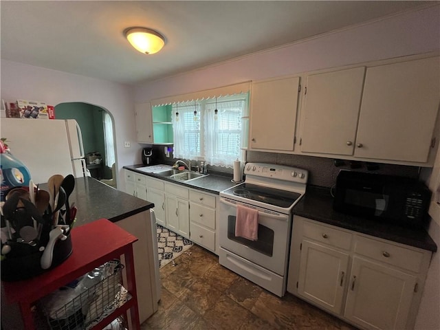 420 N 33rd St, Mattoon, IL 61938 - kitchen featuring white electric range, black microwave, dark countertops, and white cabinets