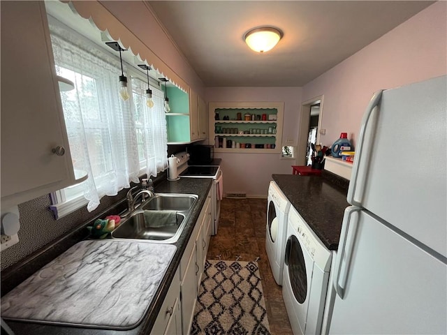 420 N 33rd St, Mattoon, IL 61938 - kitchen with freestanding refrigerator, washer and dryer, dark countertops, and white cabinetry