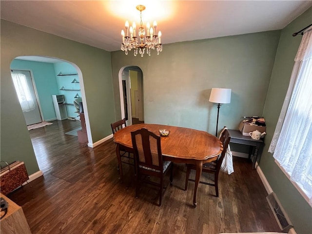 420 N 33rd St, Mattoon, IL 61938 - dining space featuring arched walkways, wood finished floors, and a chandelier