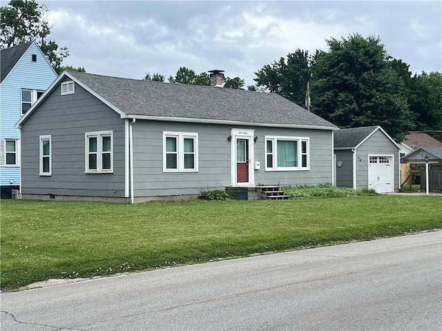 420 N 33rd St, Mattoon, IL 61938 - view of front of house with a chimney, a detached garage, roof with shingles, a front yard, and an outdoor structure