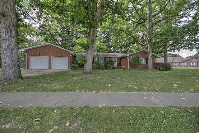 5307 Yavapai Dr, Forsyth, IL 62535 - view of front facade with brick siding, a front yard, driveway, and a garage