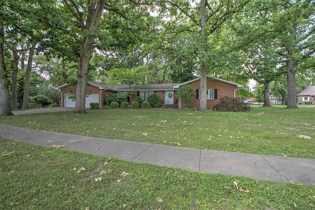 5307 Yavapai Dr, Forsyth, IL 62535 - view of front of house with a garage, brick siding, a front yard, and view of wooded area