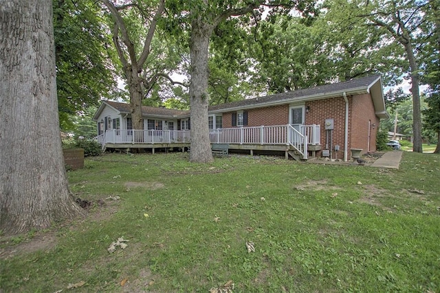 5307 Yavapai Dr, Forsyth, IL 62535 - rear view of house featuring a yard, brick siding, and a wooden deck