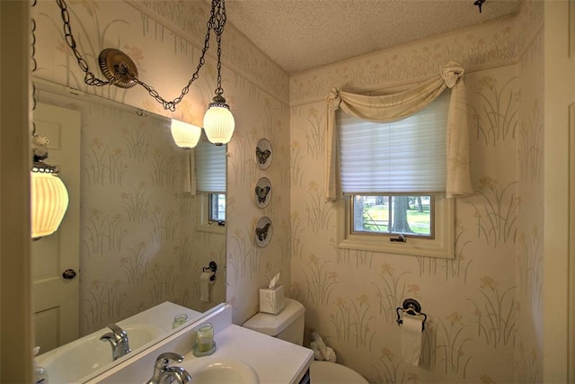 5307 Yavapai Dr, Forsyth, IL 62535 - half bath featuring wallpapered walls, vanity, and a textured ceiling