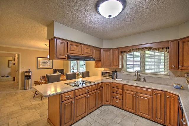 5307 Yavapai Dr, Forsyth, IL 62535 - kitchen with electric cooktop, under cabinet range hood, a peninsula, stainless steel microwave, and brown cabinets