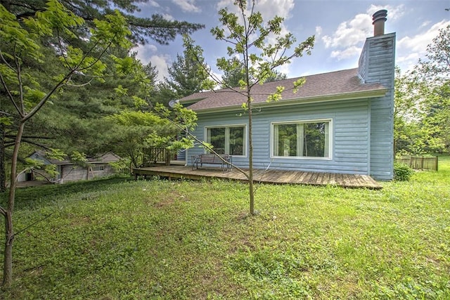 2752 N Sangamon Rd, Decatur, IL 62521 - back of house with a chimney, a wooden deck, and a lawn