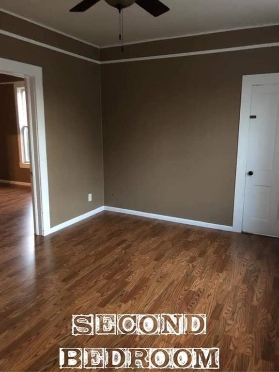 spare room featuring dark hardwood / wood-style floors and ceiling fan