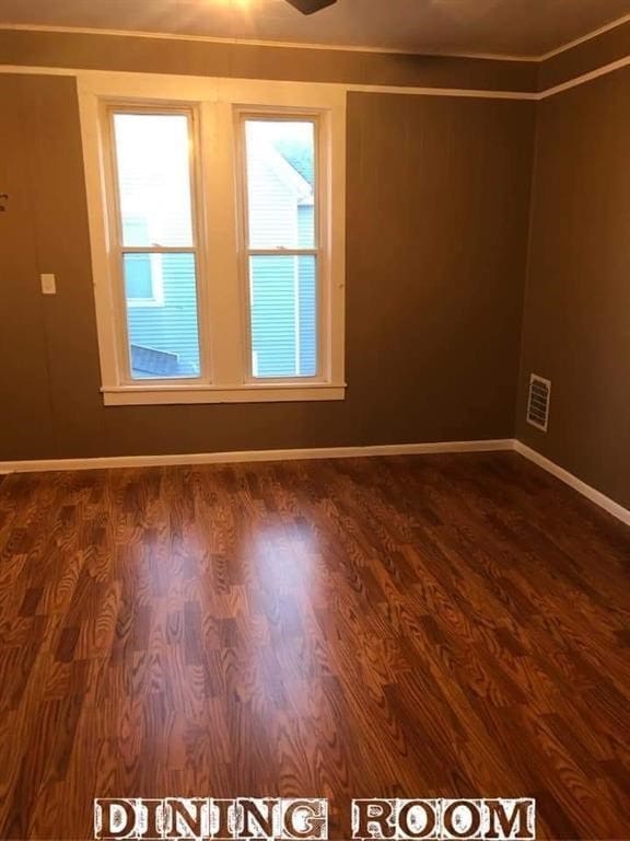 spare room featuring dark wood-type flooring