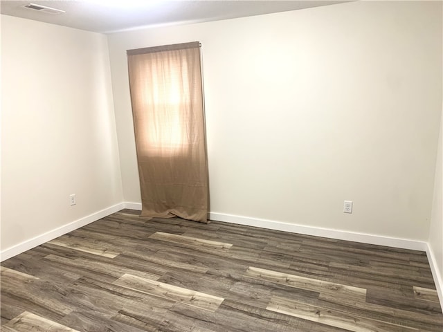 spare room featuring dark hardwood / wood-style floors