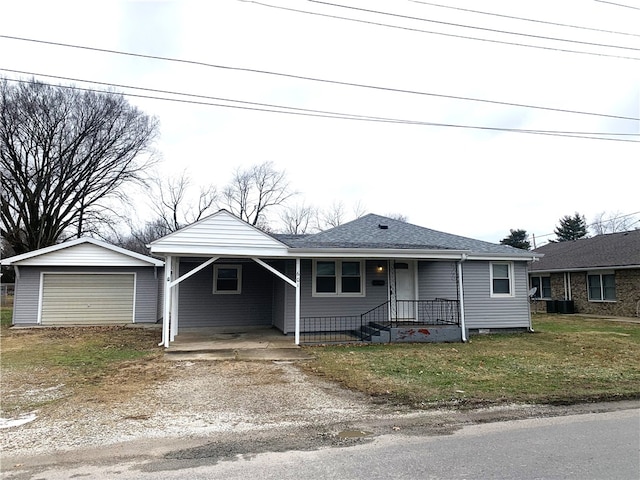 view of front of house featuring a garage, a carport, an outbuilding, and a front yard