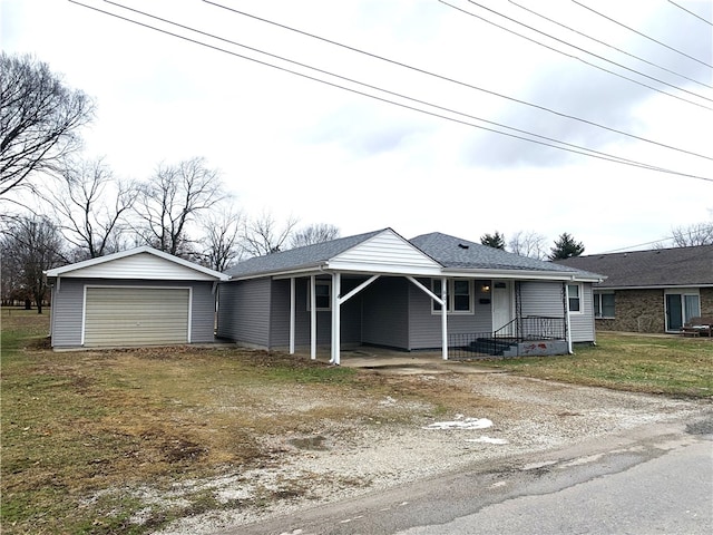 ranch-style house featuring an outbuilding, a garage, and a carport