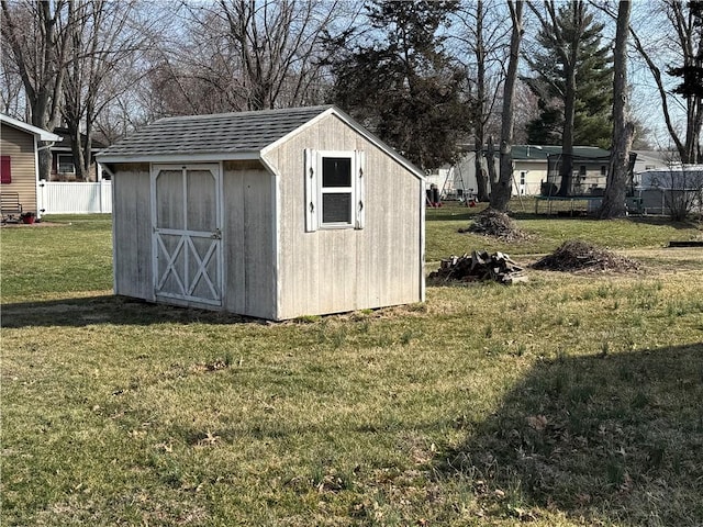 view of shed featuring fence