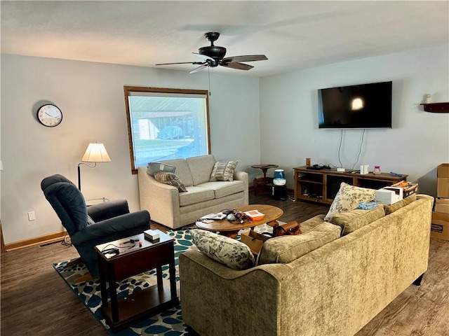 living room featuring visible vents, baseboards, wood finished floors, and a ceiling fan