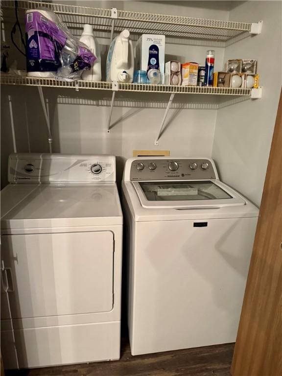 laundry area with washer and dryer, dark wood finished floors, and laundry area