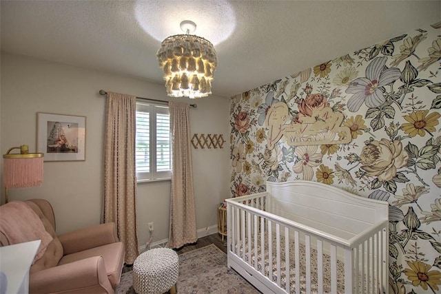 5354 N Macarthur Rd, Forsyth, IL 62535 - bedroom featuring a chandelier, a crib, wood finished floors, and a textured ceiling