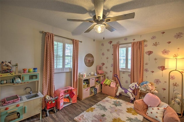 5354 N Macarthur Rd, Forsyth, IL 62535 - recreation room with dark wood-type flooring, ceiling fan, a textured ceiling, and wallpapered walls