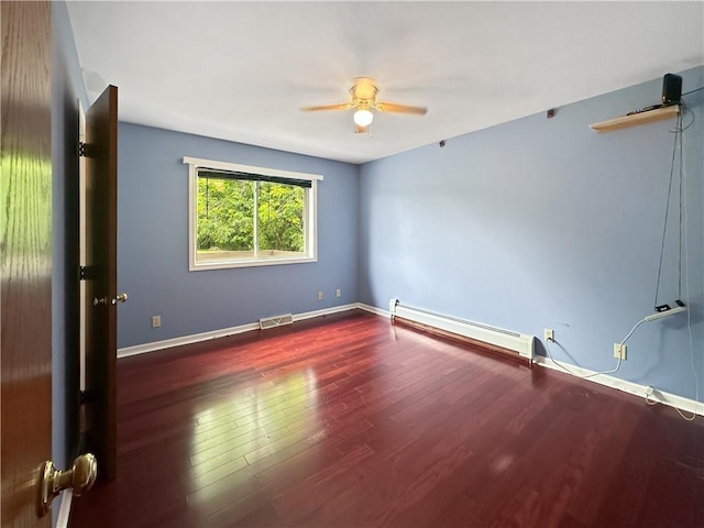 2145 E 1500 N Rd, Shelbyville, IL 62565 - empty room featuring baseboard heating, wood finished floors, ceiling fan, and baseboards
