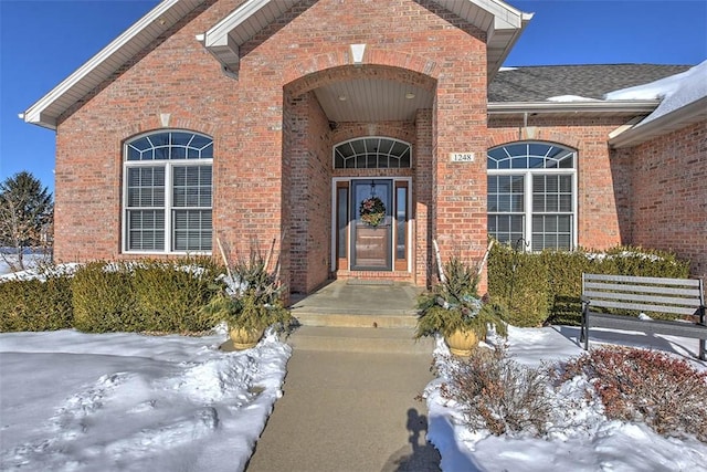 view of snow covered property entrance