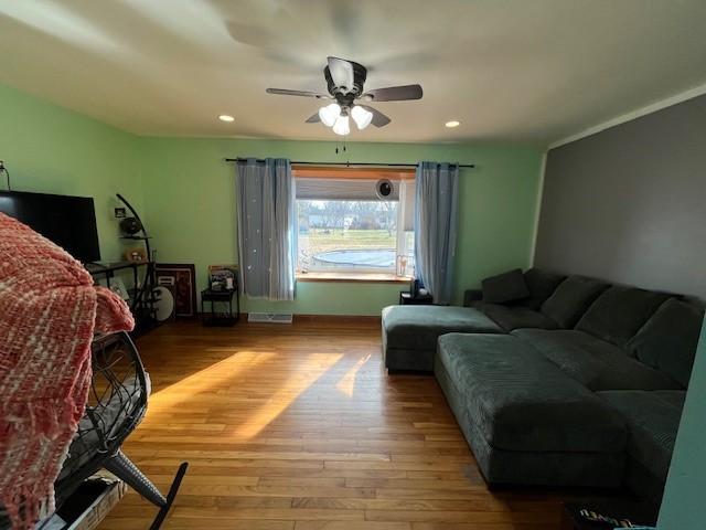 bedroom with ceiling fan and light wood-type flooring