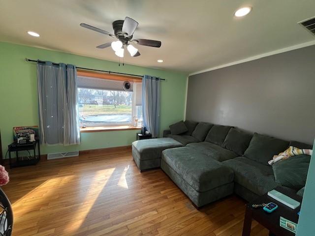 living room with hardwood / wood-style flooring and ceiling fan