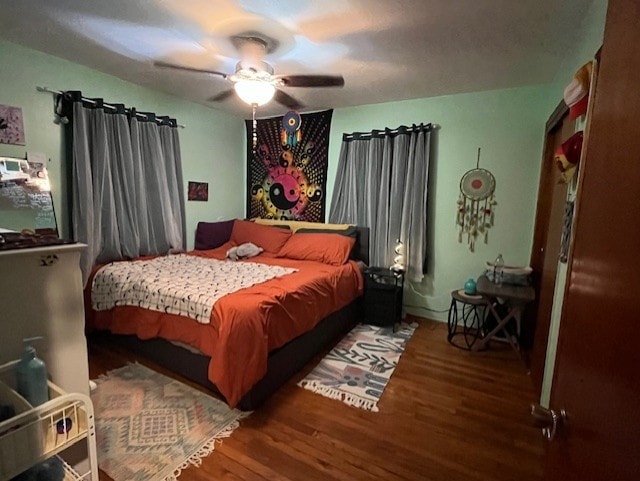 bedroom with hardwood / wood-style floors and ceiling fan