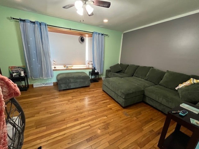 living room featuring ceiling fan and light hardwood / wood-style flooring