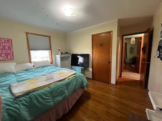 bedroom with dark hardwood / wood-style flooring