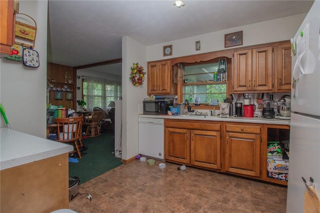 1104 N 30th St, Mattoon, IL 61938 - kitchen featuring white appliances, light countertops, and brown cabinetry