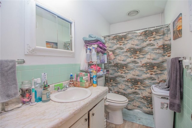 1104 N 30th St, Mattoon, IL 61938 - bathroom featuring tile walls, vanity, wood finished floors, and a shower with curtain