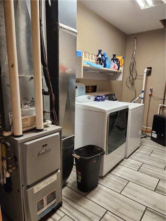 1422 Ohio Ave, Windsor, IL 61957 - laundry room with washing machine and dryer, wood finish floors, and heating unit