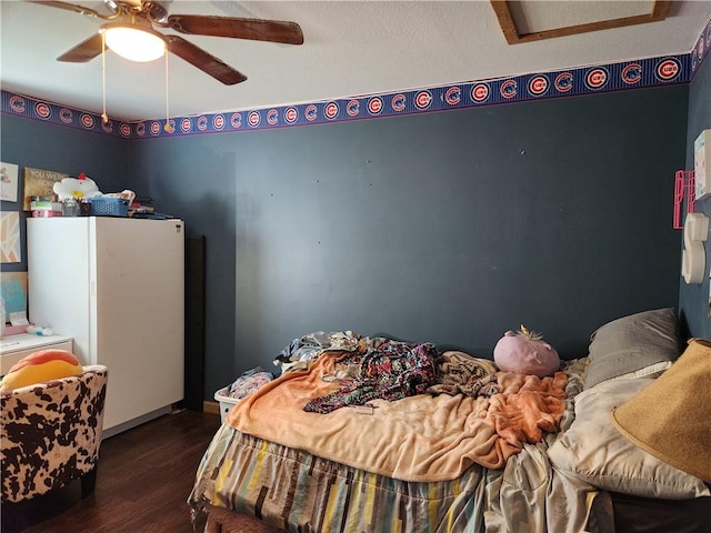 1422 Ohio Ave, Windsor, IL 61957 - bedroom featuring wood finished floors, freestanding refrigerator, ceiling fan, and attic access