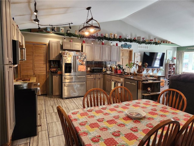 1422 Ohio Ave, Windsor, IL 61957 - kitchen with appliances with stainless steel finishes, vaulted ceiling, dark countertops, backsplash, and open floor plan