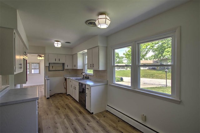 2631 Gregory Ct, Decatur, IL 62526 - kitchen featuring a baseboard radiator, a sink, black dishwasher, and healthy amount of natural light
