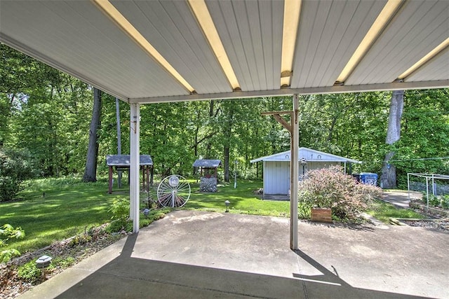 2631 Gregory Ct, Decatur, IL 62526 - view of patio featuring an outbuilding, a shed, and view of scattered trees