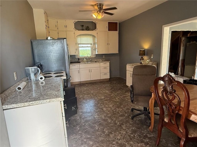 5296 E County Road 1100n, Mattoon, IL 61938 - kitchen featuring ceiling fan, freestanding refrigerator, light countertops, and white cabinets
