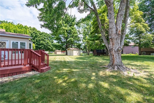 4642 Dogwood Ct, Decatur, IL 62526 - view of grassy yard with a storage shed and a deck