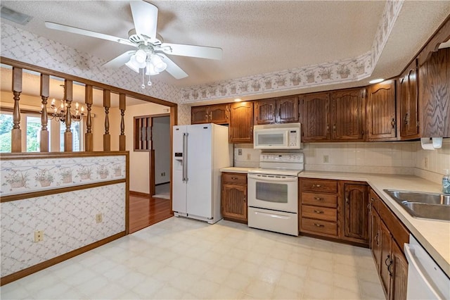 4642 Dogwood Ct, Decatur, IL 62526 - kitchen with white appliances, wallpapered walls, light flooring, ceiling fan, and light countertops