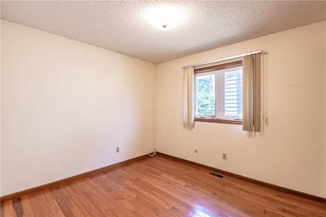 4642 Dogwood Ct, Decatur, IL 62526 - spare room with light wood-type flooring and a textured ceiling