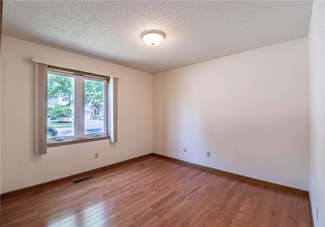 4642 Dogwood Ct, Decatur, IL 62526 - spare room featuring light wood finished floors and a textured ceiling