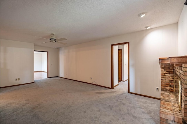 4642 Dogwood Ct, Decatur, IL 62526 - unfurnished living room with carpet flooring, ceiling fan, a textured ceiling, and a fireplace