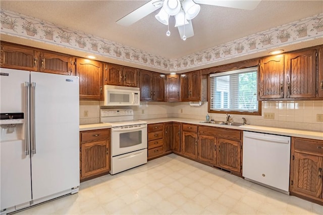 4642 Dogwood Ct, Decatur, IL 62526 - kitchen with white appliances, light flooring, light countertops, ceiling fan, and backsplash