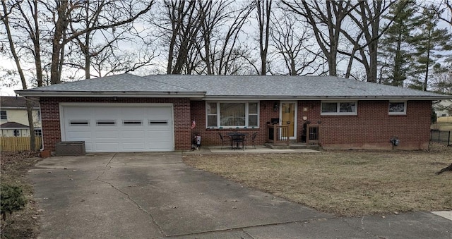 ranch-style house with brick siding, driveway, a garage, and fence