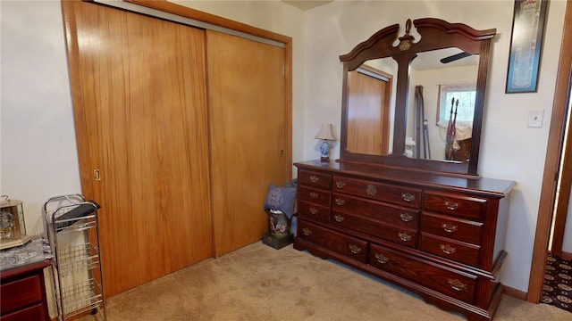 bedroom featuring a closet and light carpet