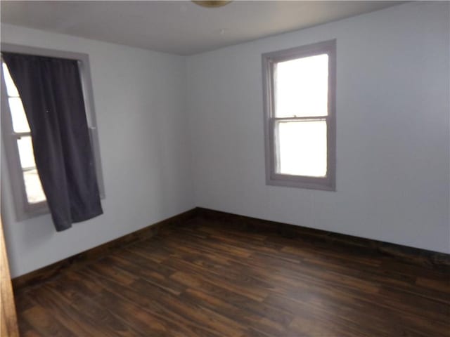 empty room featuring dark hardwood / wood-style flooring